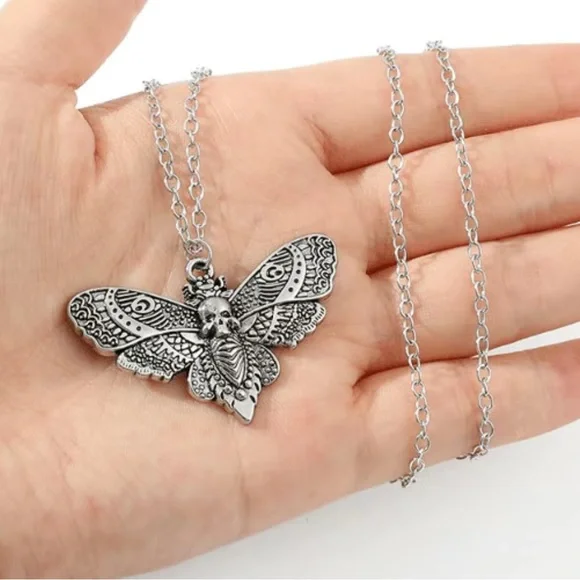 Skull moth earrings representing resilience - Picture 3 of 5